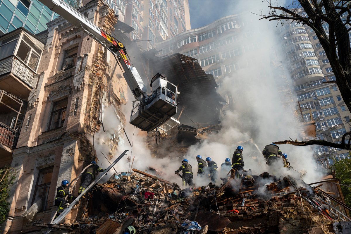 <i>Roman Hrytsyna/AP</i><br/>Firefighters work after a drone attack on buildings in Kyiv
