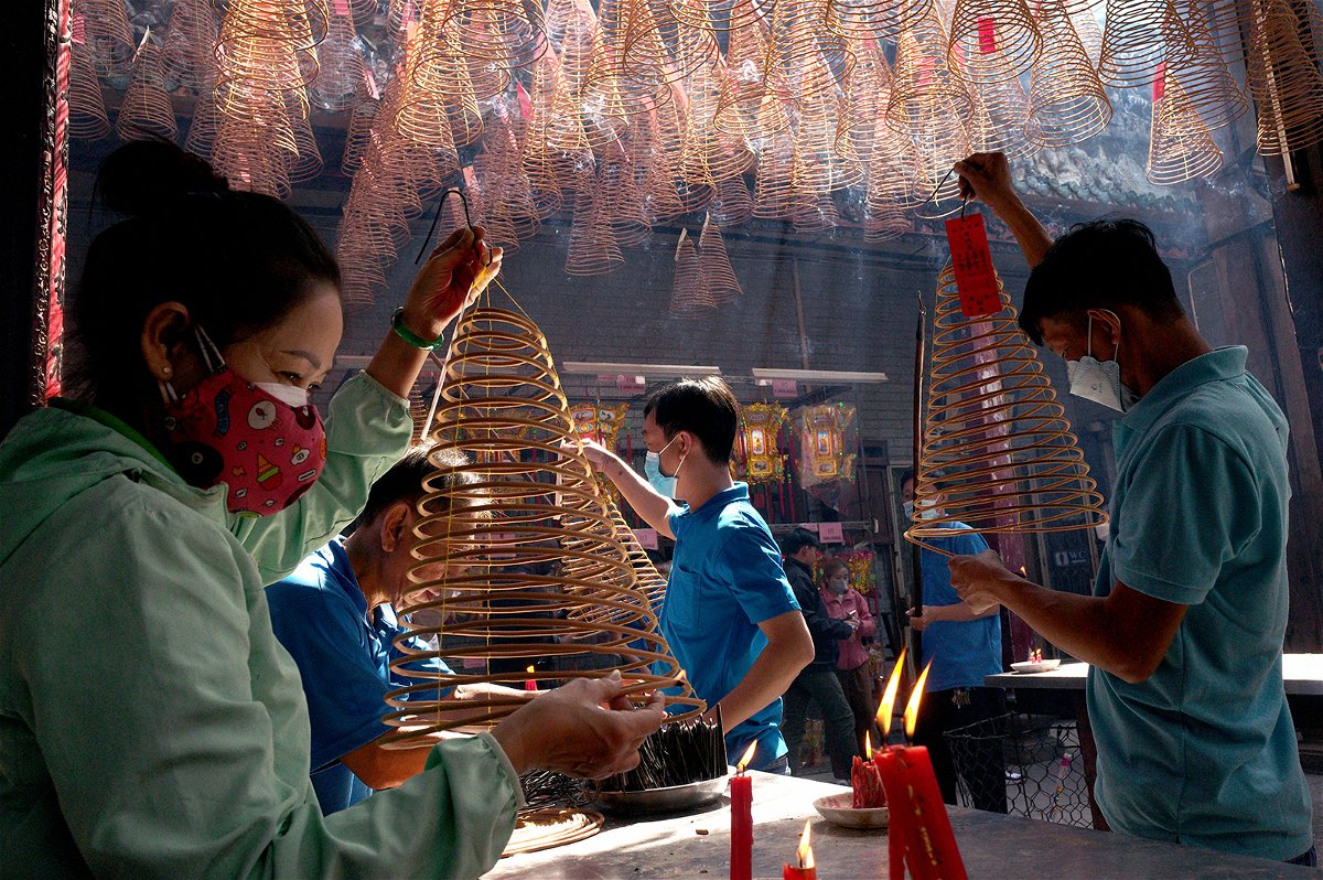 <i>Nick Ut/Getty Images</i><br/>People pray over incense at Thien Hau Pagoda for the Tet Lunar New Year on January 24 in Ho Chi Minh City