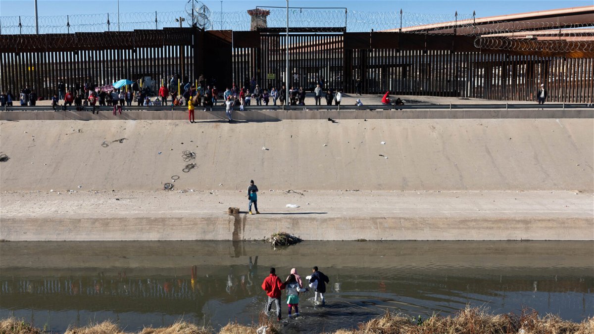 <i>John Moore/Getty Images</i><br/>Immigrants cross the Rio Grande into El Paso