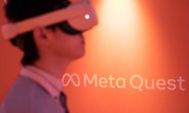 An attendee wearing a Meta Quest 2 VR headset plays a video game at the Tokyo Game Show 2022 in September of 2022 in Chiba