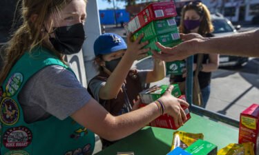 It's Girl Scout cookie season again. Two young girls sell Girl Scout cookies in Los Angeles on February 11