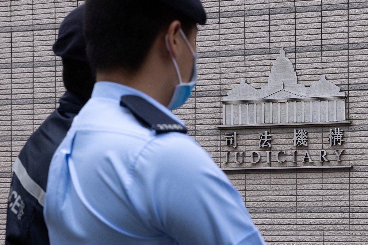 <i>Tyrone Siu/Reuters</i><br/>Police stand guard outside the West Kowloon Magistrates' courts in Hong Kong on November 25