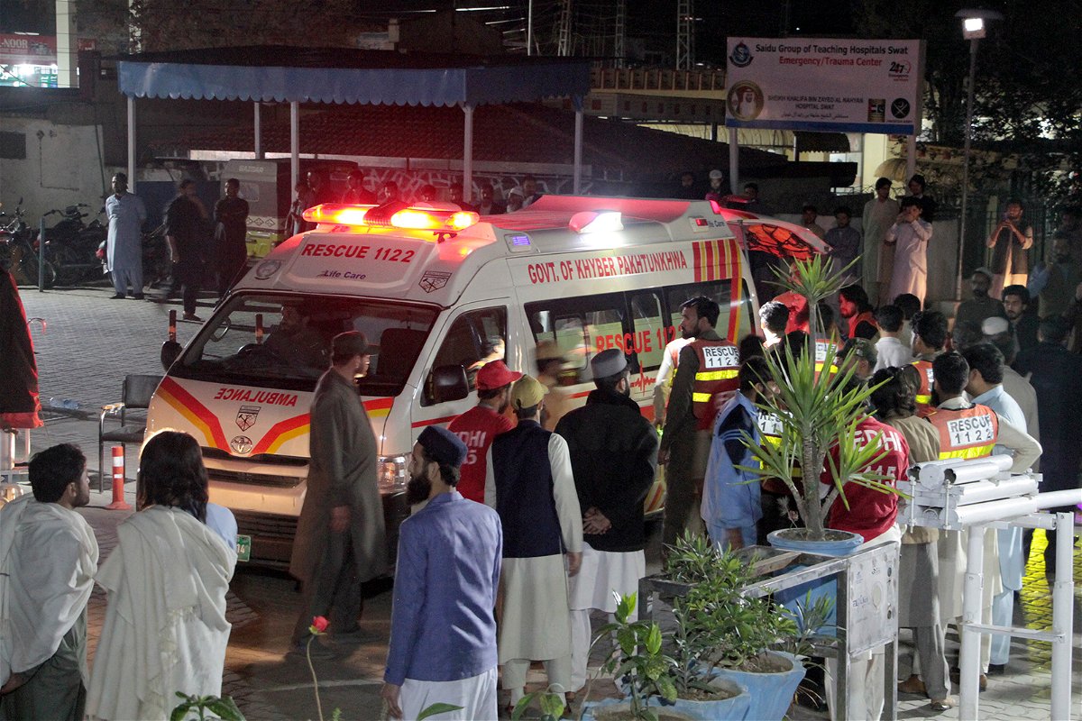 <i>Naveed Ali/AP</i><br/>Rescue worker unload earthquake victims from an ambulance at a hospital in Saidu Sharif