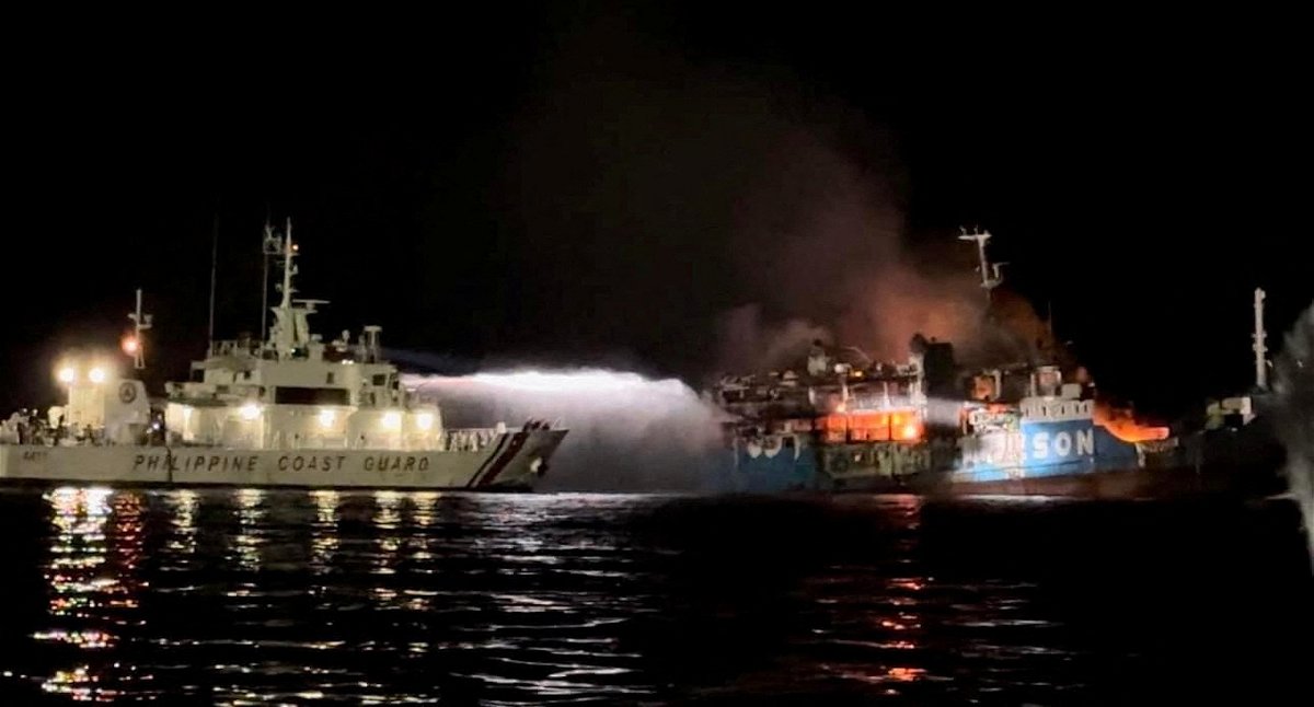 <i>Philippine Coast Guard/Reuters</i><br/>The Philippine Coast Guard responds to the fire aboard a passenger ferry in waters off Baluk-Baluk Island