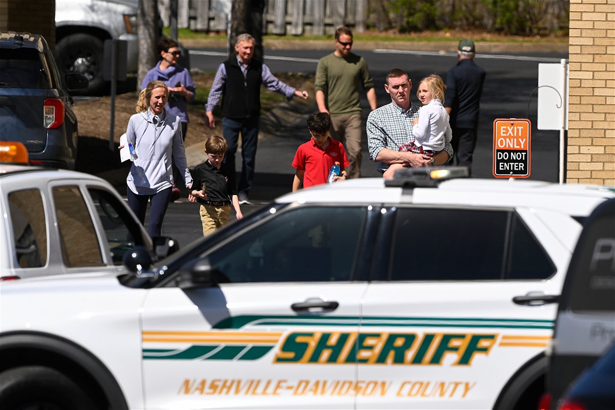<i>John Amis/AP</i><br/>Families leave a reunification site in Nashville on Monday following the deadly school shooting.
