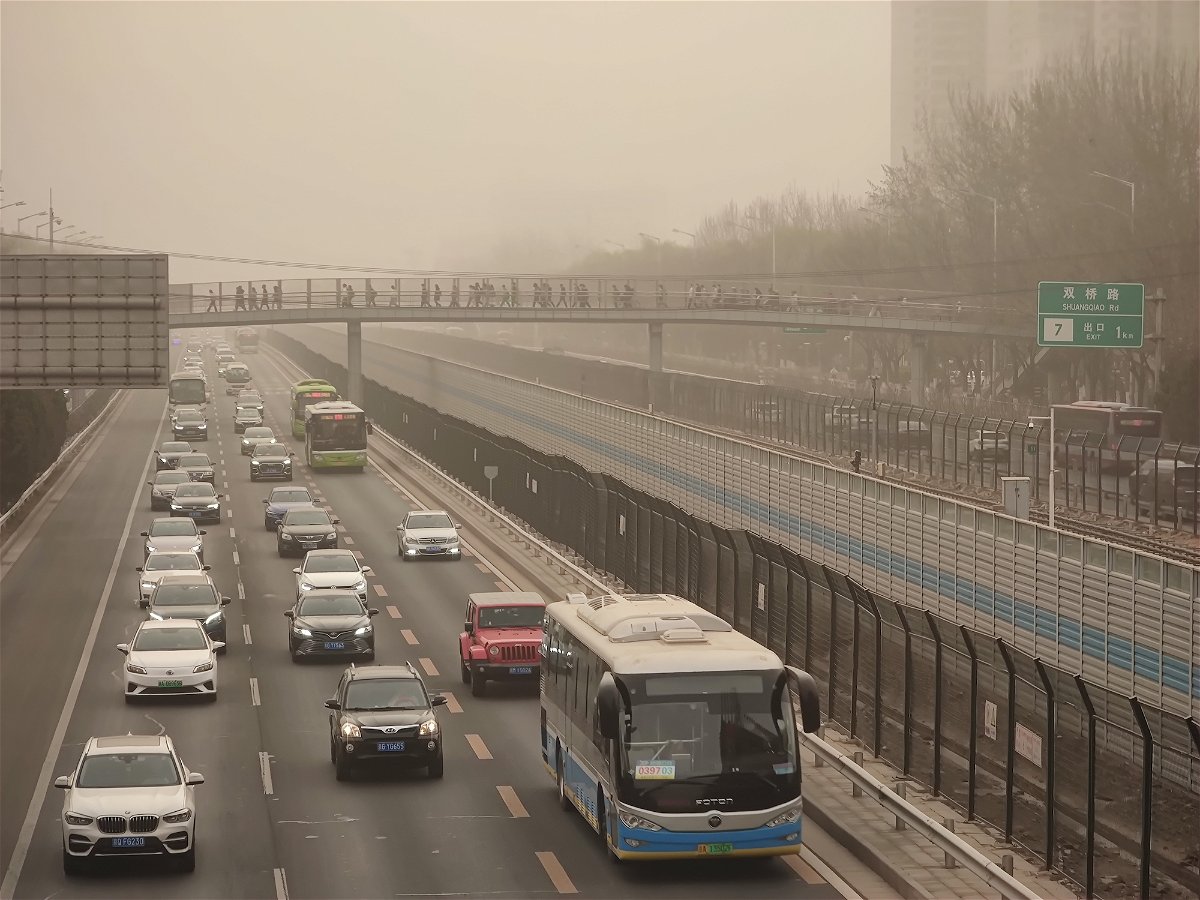 <i>Feng Li/VCG/Getty Images</i><br/>Cars drive in low-visibility through a sandstorm on March 22