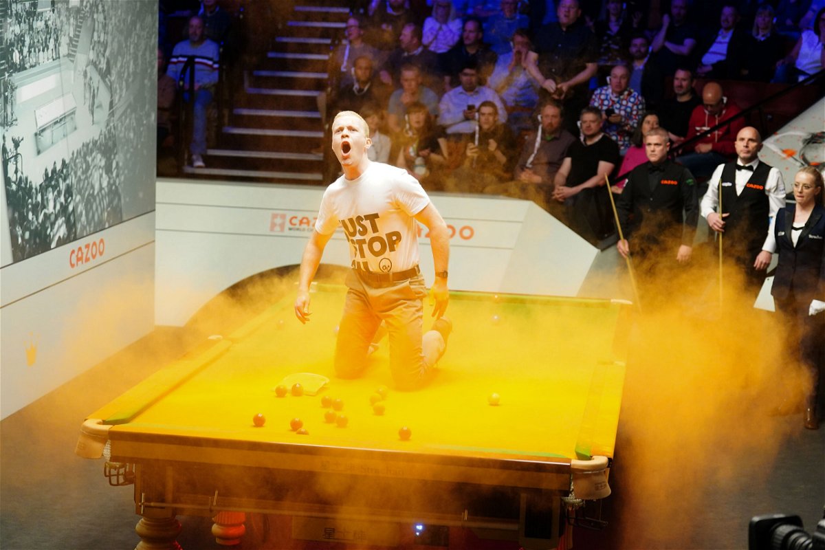 Just Stop Oil protester disrupts World Snooker Championship by throwing orange powder paint on table News Channel 3-12