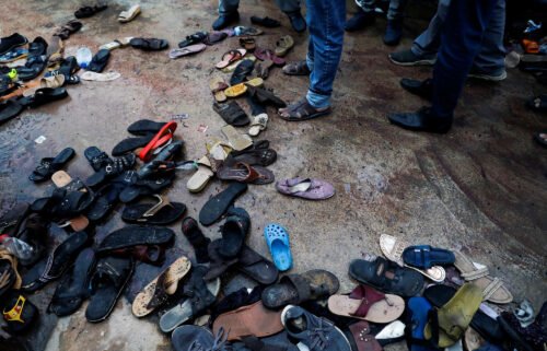 A view of a site with a pile of footwear after a stampede occurred during handout distribution