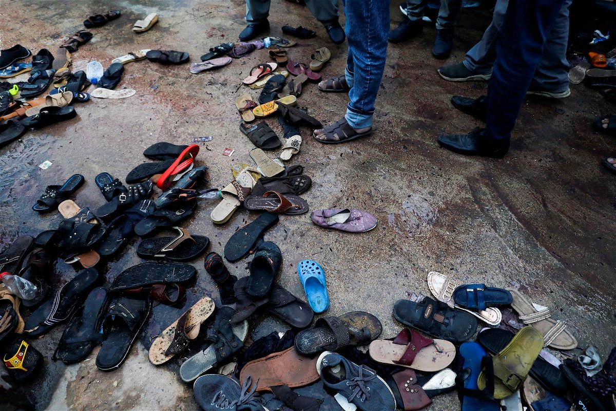 <i>Akhtar Soomro/Reuters</i><br/>A view of a site with a pile of footwear after a stampede occurred during handout distribution