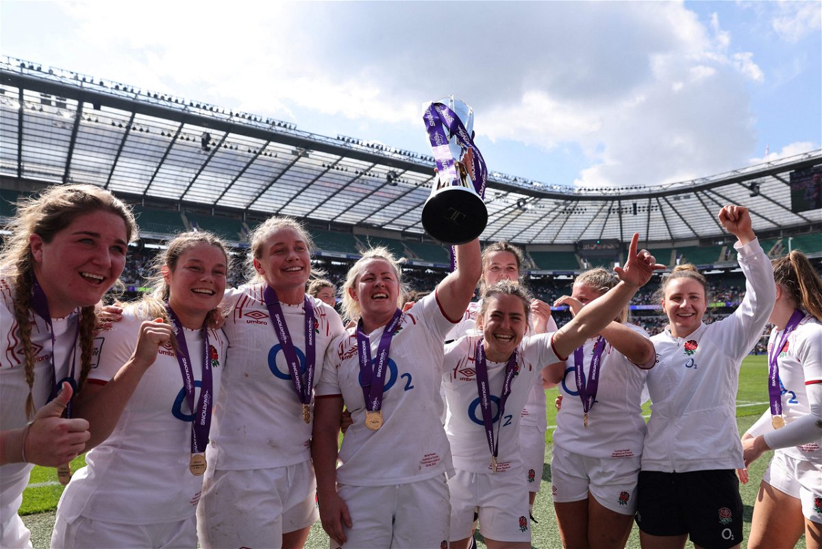 <i>Adrian Dennis/AFP/Getty Images</i><br/>England's flanker and captain Marlie Packer celebrates with the trophy and teammates.