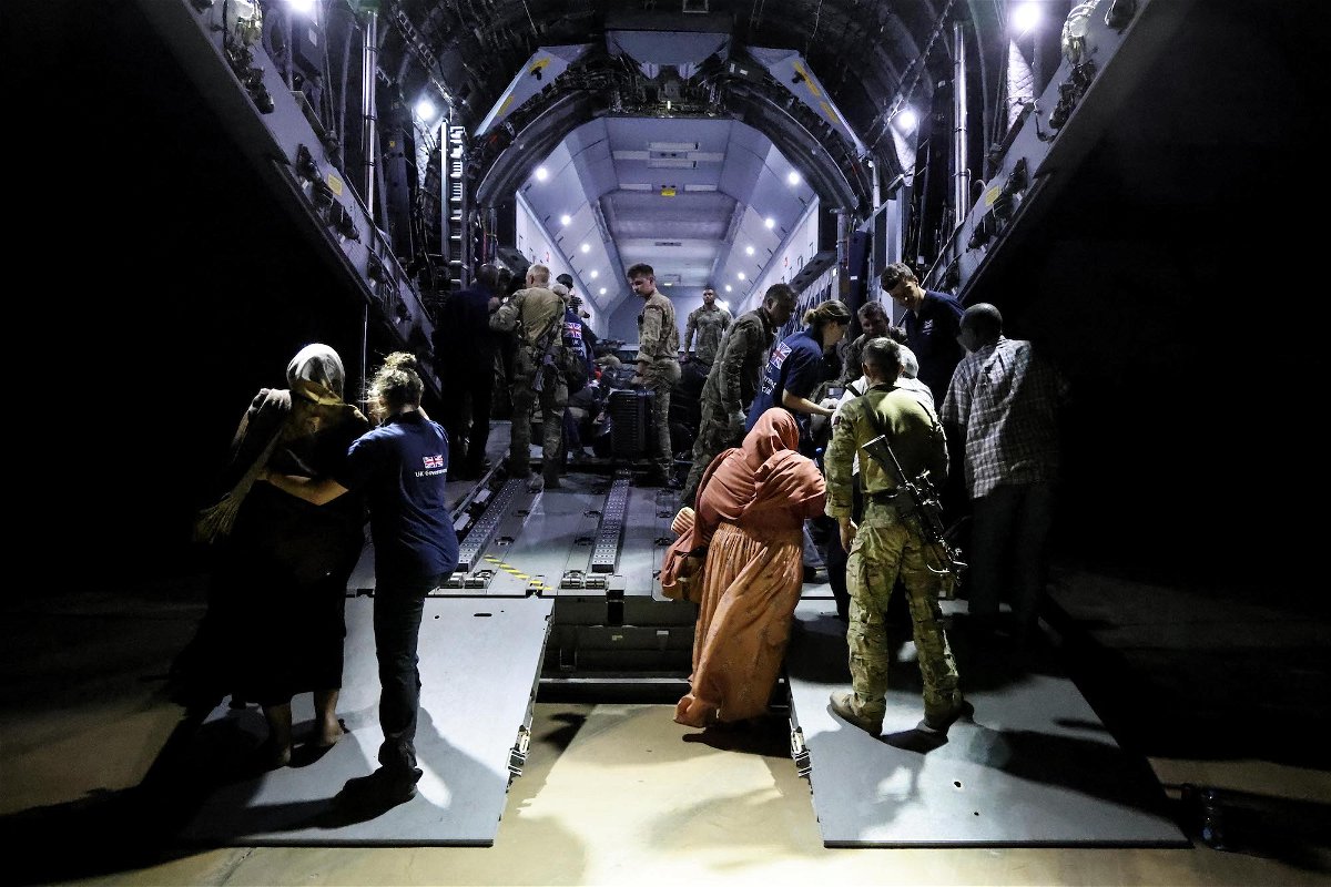 <i>British Ministry of Defence/Getty Images</i><br/>British citizens seen boarding an RAF aircraft in Sudan for evacuation to Cyprus.