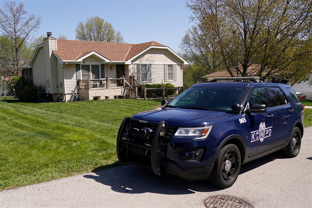 <i>Charlie Riedel/AP</i><br/>A police officer drives past the house on April 17