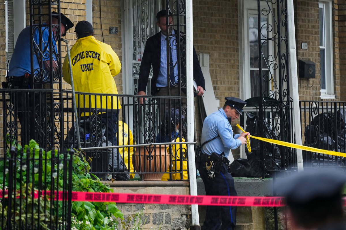 <i>Matt Rourke/AP</i><br/>Investigators work the scene of a quadruple shooting Friday in Philadelphia.
