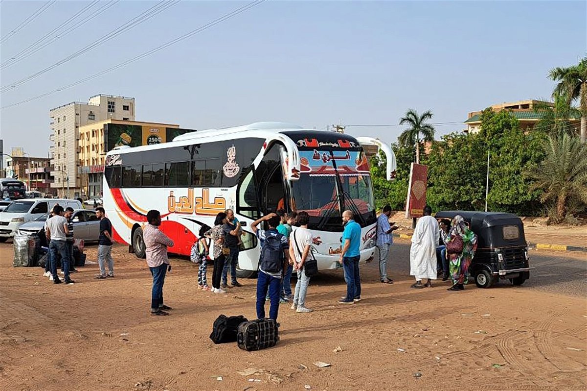 <i>Ahmed Satti/Anadolu Agency/Getty Images</i><br/>People wait to board a bus on Tuesday in Sudan's capital