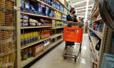 A customer looks over merchandise at a store on March 14