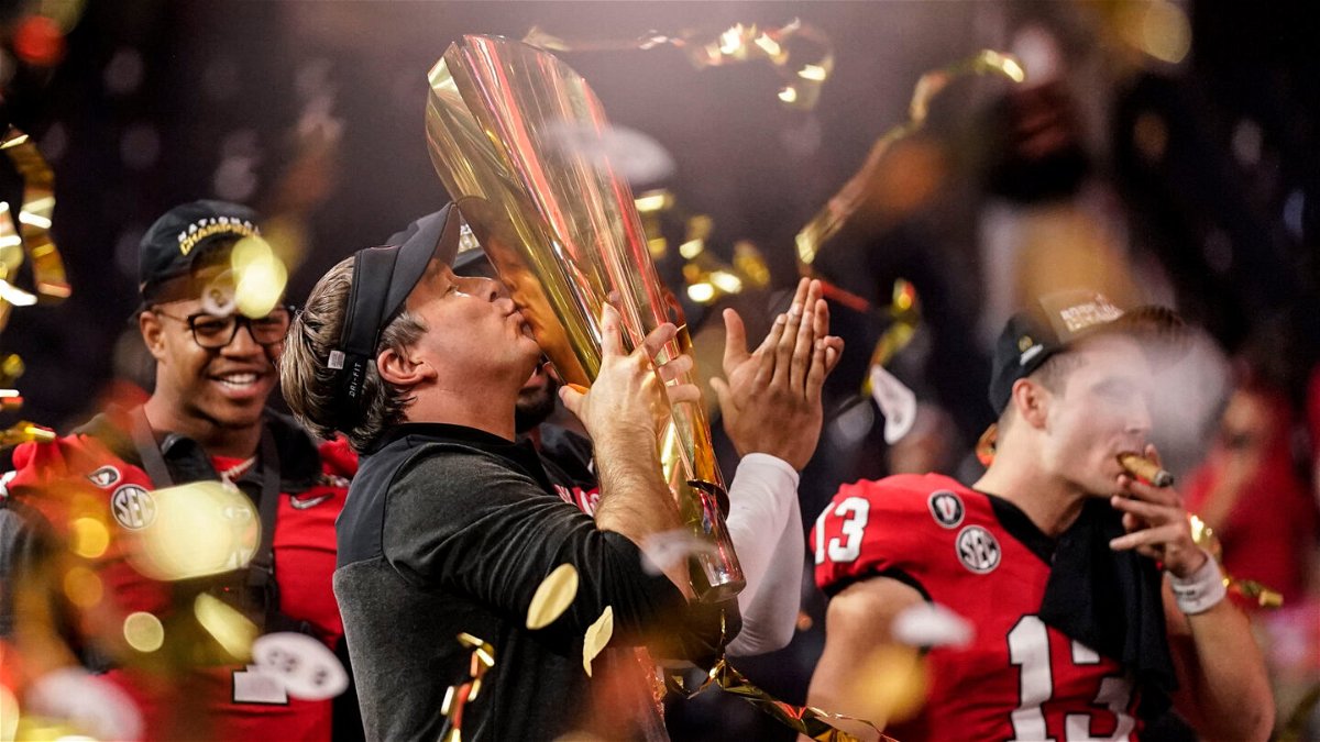 <i>Ashley Landis/AP</i><br/>Georgia head coach Kirby Smart kisses the championship trophy after the national championship NCAA College Football Playoff game against TCU
