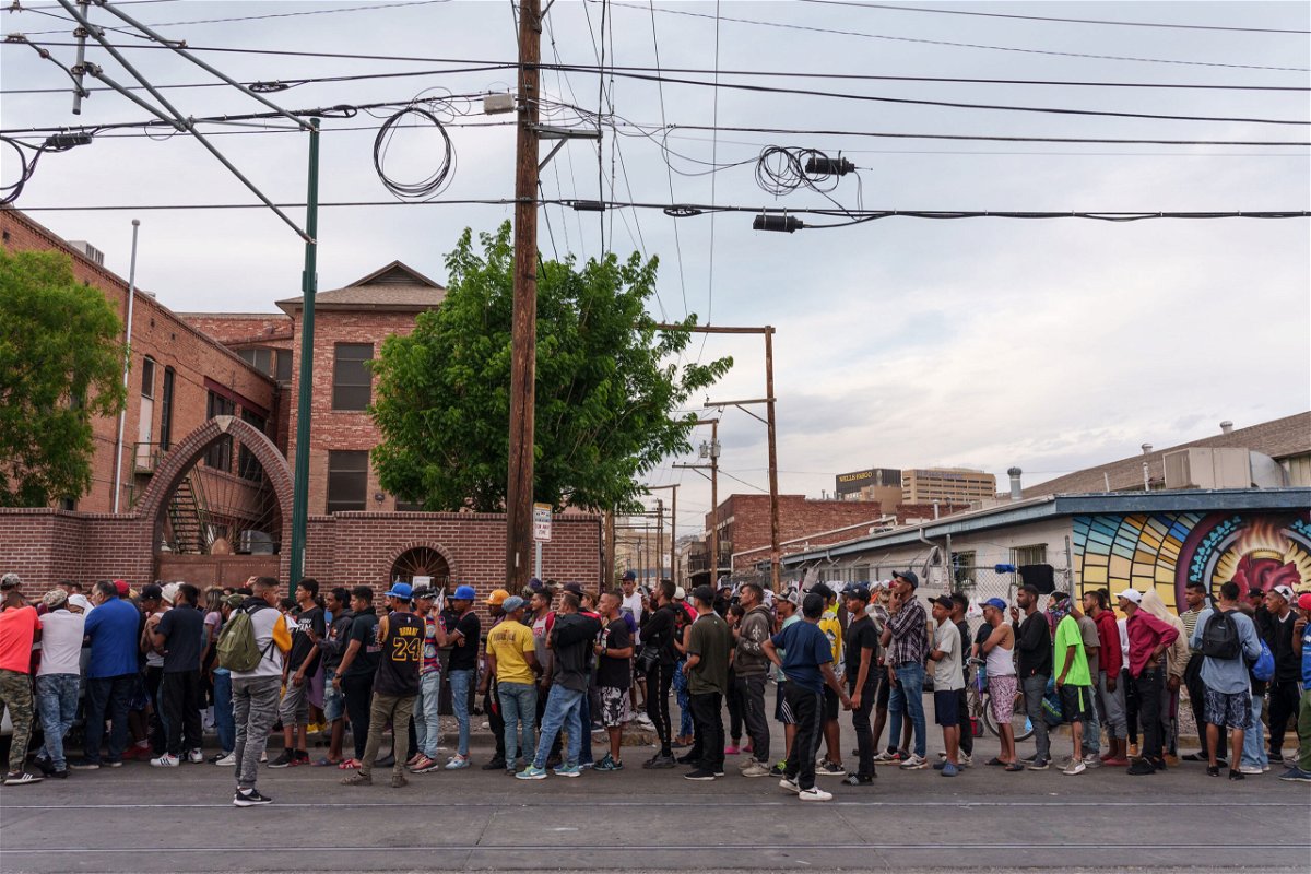 <i>Paul Ratje/Bloomberg/Getty Images</i><br/>Migrants wait in line for donations outside of Sacred Heart Church in El Paso last Wednesday.