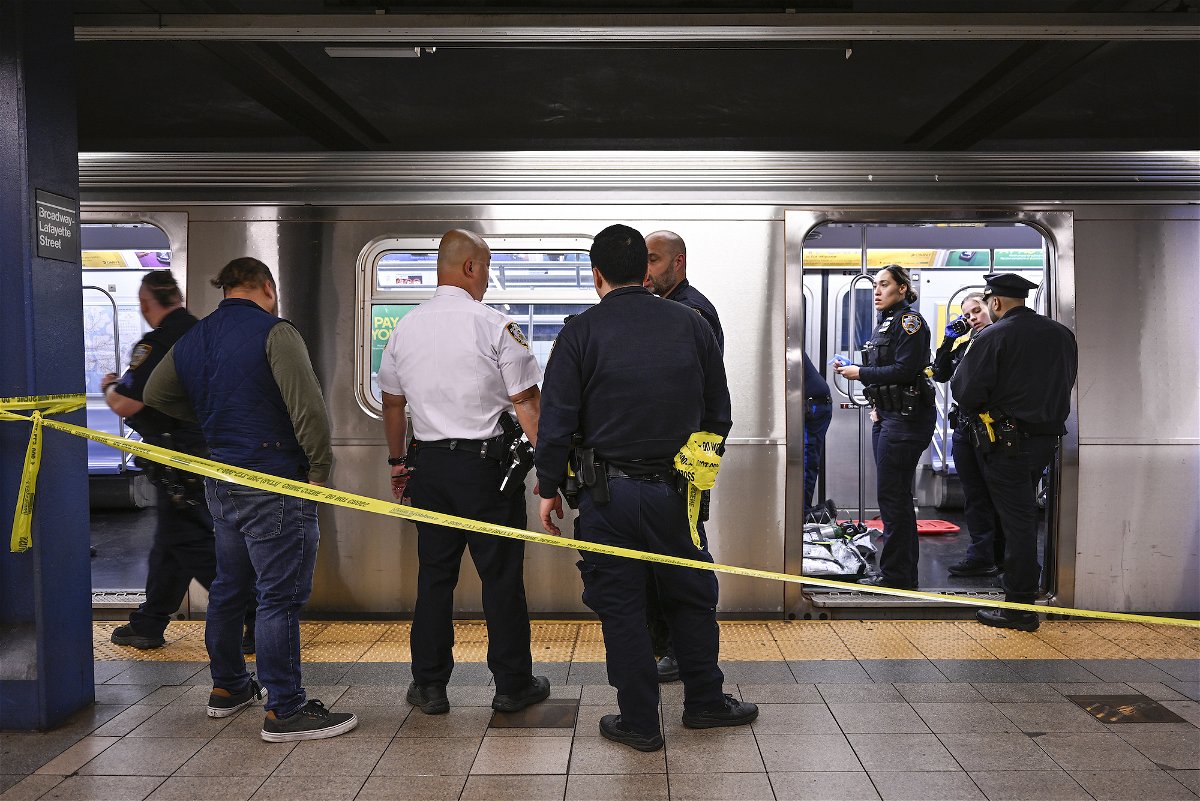 <i>Paul Martinka/AP</i><br/>New York police officers respond after a man riding the subway was placed in a chokehold by another passenger on Monday.