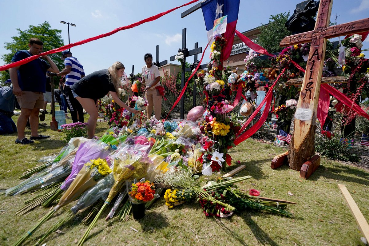 <i>Tony Gutierrez/AP</i><br/>Mourners leave flowers at a makeshift memorial for the victims of the mass shooting in Allen