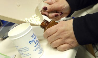 A pharmacist dispenses diazepam tablets