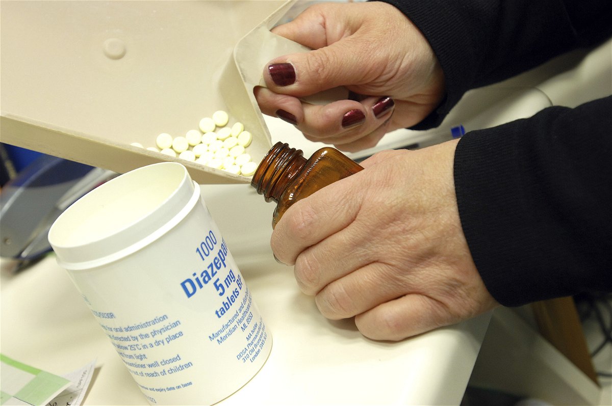 <i>Medicimage/Shutterstock</i><br/>A pharmacist dispenses diazepam tablets