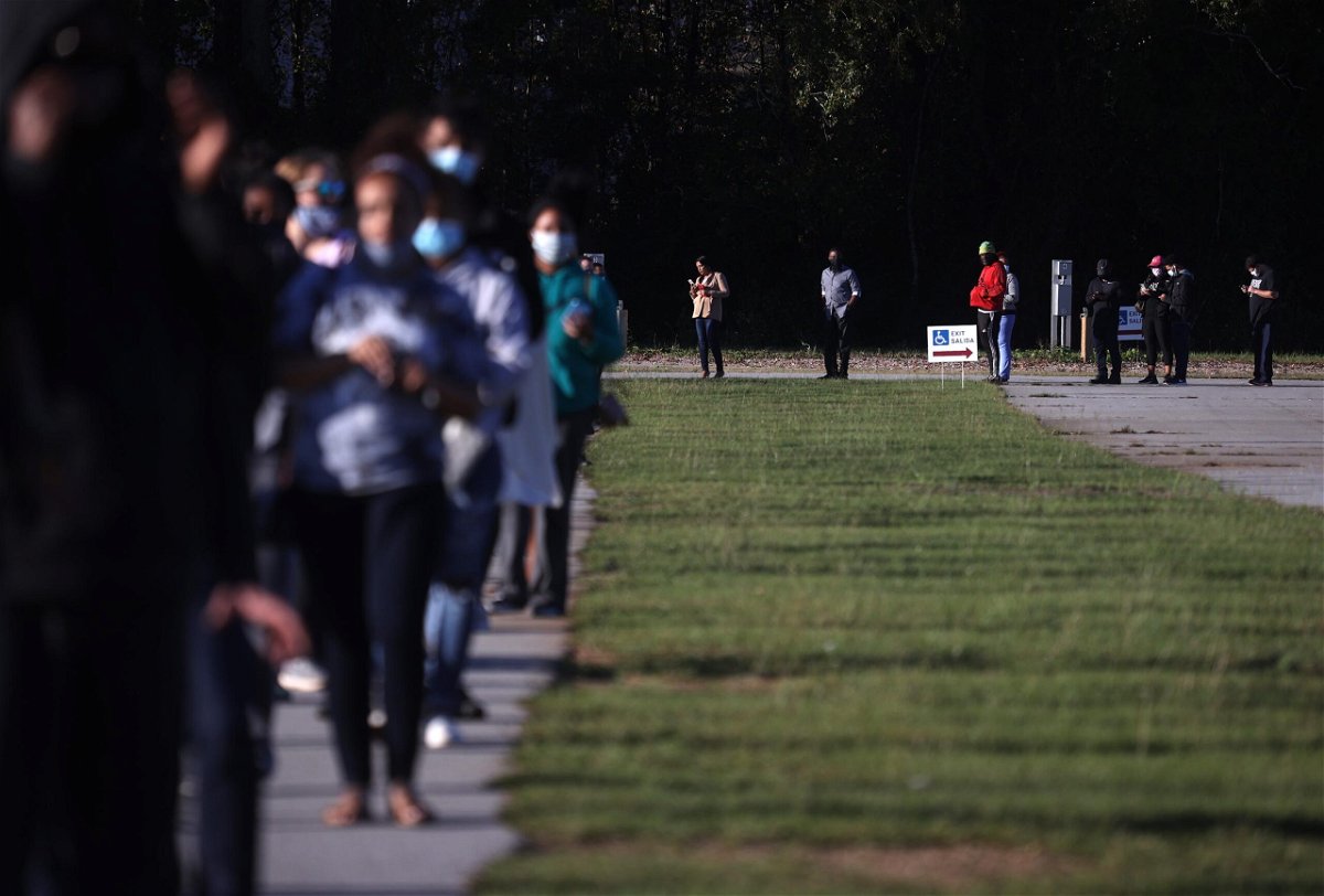 <i>Justin Sullivan/Getty Images</i><br/>People line up to vote at the Gwinnett County Fairgrounds in October 2020 in Lawrenceville