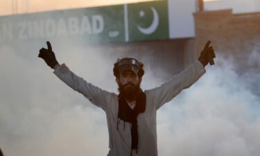 A demonstrator is seen as Pakistani police use tear gas against supporters of former Prime Minister Imran Khan during a protest in Peshawar