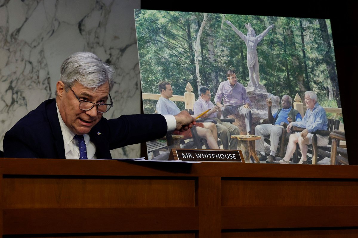 <i>Chip Somodevilla/Getty Images</i><br/>Senate Judiciary Committee member Sen. Sheldon Whitehouse (D-RI) displays a photo featuring Supreme Court Justice Clarence Thomas alongside other conservative leaders during a hearing on Supreme Court ethics reform on Capitol Hill on May 02