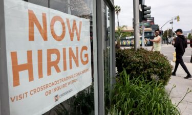 A 'Now Hiring' sign is displayed outside a resale clothing shop on Friday in Los Angeles