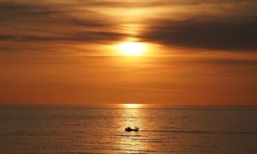 A fishing boat heads out to sea off the coast of Tynemouth on the North East coast of England.