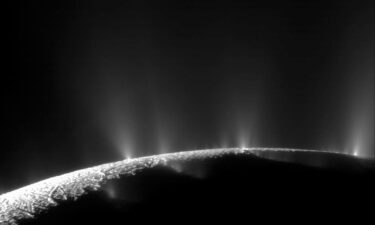 Wispy arcs of icy material expand out from Enceladus (brightest white dot above) into Saturn's E ring.