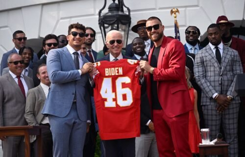 Mahomes and Kelce present President Biden with a Chiefs jersey.