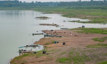 People fish along exposed banks