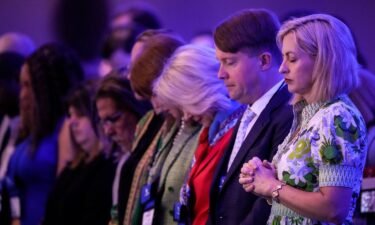 Attendees bow their heads in prayer at the start of the Faith & Freedom Coalition's policy conference in Washington
