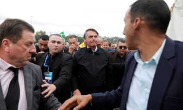 Former Brazilian President Jair Bolsonaro’s trial on charges of abuse of political power and misuse of public media began on June 22 in Brasilia. Bolsonaro is pictured here with supporters on Thursday.