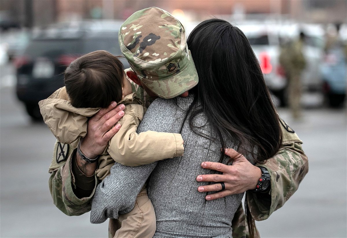 U.S. Army SSG. Tyler Laliberte embraces his family after returning from a 9-month deployment to Afghanistan on December 10