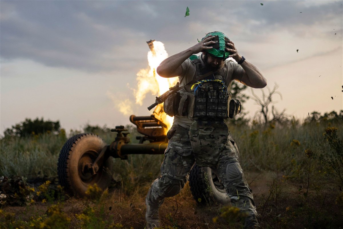 A Ukrainian serviceman of the 3rd Assault Brigade fires a 122mm mortar towards Russian positions at the front line