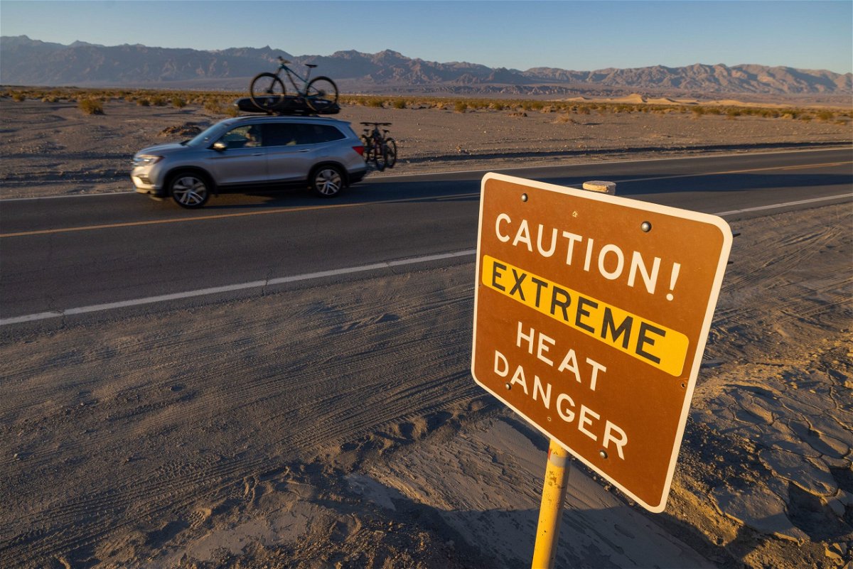 A car passes a sign warning of extreme heat danger on July 15