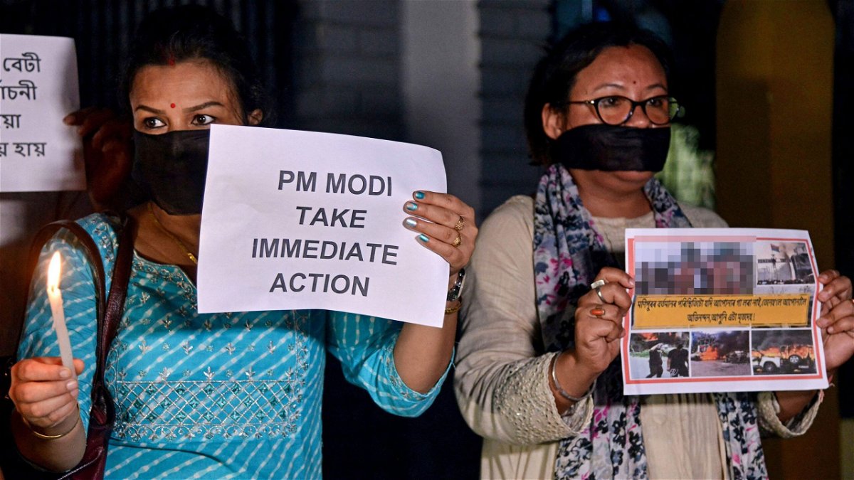 Protesters hold placards during a demonstration over sexual violence against women in Manipur