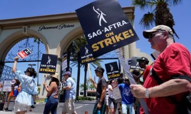 Striking writers and actors take part in a rally outside Paramount studios in Los Angeles on Friday