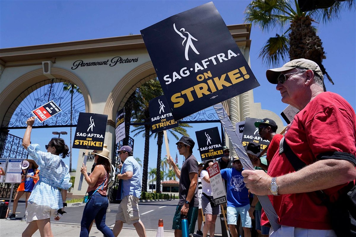 Striking writers and actors take part in a rally outside Paramount studios in Los Angeles on Friday
