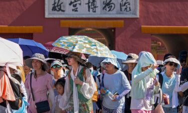 Visitors leaving the Forbidden City on a hot day in Beijing