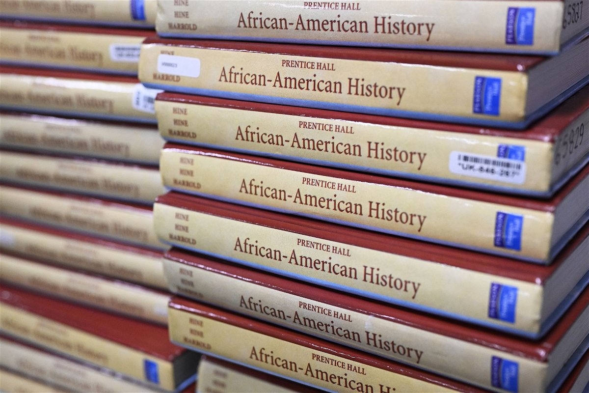 Books are piled in a classroom for students taking AP African American Studies at Overland High School in Aurora