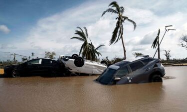 Downed electrical poles and lines blown over by Hurricane Otis blanket a road in Acapulco