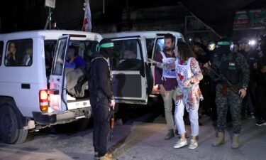 Members of the Red Cross prepare to transport hostages released by Hamas in Rafah