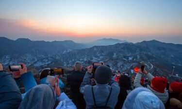 Tourists step on the Great Wall to watch sunrise on New Year's Day on January 1