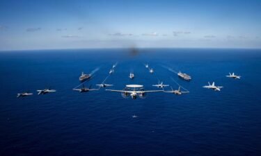 US Navy aircraft fly in formation during an exercise held in the Philippine Sea on January 31.