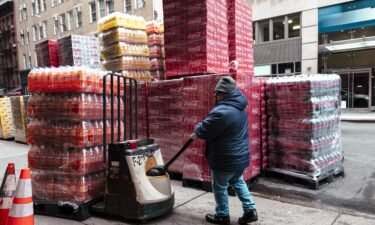 A worker moves pallets of soft drinks outside a beverage distribution company in New York on January 29