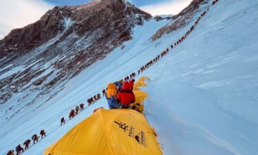 This photograph from 2021 shows mountaineers lined up as they climb a slope during their ascent to summit Mount Everest.