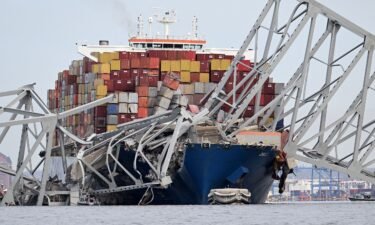 The steel frame of the Francis Scott Key Bridge sits on top of the container ship Dali after the bridge collapsed
